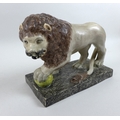 A 19th century Staffordshire figure, modelled as a Medici lion, in standing pose with left paw resti... 