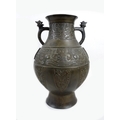 A 19th century Chinese bronze Hu style archaic vase, its main body with two bands of relief decorati... 