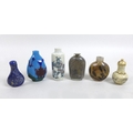 A group of six Chinese snuff bottles, comprising a 19th century cylindrical porcelain example with g... 