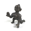 An early 20th century Indian bronze figurine of the infant Krishna, crawling whilst holding a ball o... 