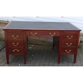 A mid 20th century mahogany desk, by Cooke's (Finsbury) Ltd, six drawers to two pedestals inset blac... 