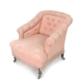 A Victorian salon armchair, with squared back and scroll over arms, upholstered in buttoned pink fol... 