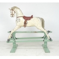 An Edwardian G & J Lines extra carved rocking horse, painted dapple grey horse with brown leather sa... 