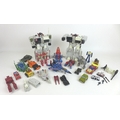 A group of nine 1980s Transformers toy action figures, including Hot-Rod, two Metroplex figures, and... 