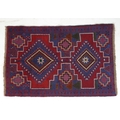 A Gazak rug with two diamond medallions, 127 by 83cm.