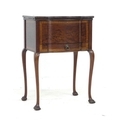 A 20th century mahogany sewing table, its fitted interior with dressing table items, the exterior wi... 