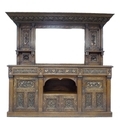An Arts and Crafts oak carved sideboard by Edward Bowman, with mirrored gallery back, three frieze d... 