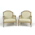 A pair of French 19th century giltwood armchairs, with carved gilt frames, upholstered in cream foli... 