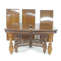A French oak dining table, the rectangular surface with rounded corners and moulded edges, three add... 