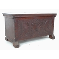 An 18th century stained pine and oak blanket chest, of small proportions, carved front panel with lu... 