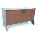 An 18th century stained pine blanket chest, of plain form with saw cut feet, lift lid and candle box... 