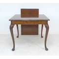 A good quality burr walnut veneered extending dining table, circa 1940, in Queen Anne style, with mo... 