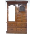 A Victorian mahogany compactum wardrobe, with decorative carved panels, short mirrored door, small c... 