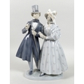 A Royal Copenhagen porcelain figural group, modelled as a Victorian lady and gentleman, model 1593, ... 