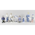 A group of eight porcelain figurines, comprising two Royal Copenhagen figurines, modelled as a littl... 