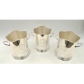 Three nickel plated Louis Roederer style champagne buckets, made in India, with cloth covers. (3)