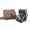 A vintage Zeiss Ikon bellows camera, with vintage leather case.