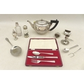 A group of silver plate, including a teapot, a cased Christening set, dwarf candlestick, a white met... 