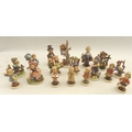A group of seventeen Hummel figures, including 'Out of Danger' 8 by 16cm high. (17)