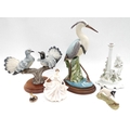 A group of sculptures and ceramics, including a Capodimonte sculpture of a stork, another of two bir... 