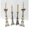 Two pairs of distressed wooden table lamps, the largest with gilt decoration, 67.5cm overall, both r... 