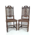 A pair of oak Jacobean style dining chairs, carved frames with fruiting vines and barley twist sides... 