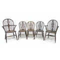 A composite set of five wheelback Windsor chairs, comprising a 19th century open armchair, a 20th ce... 