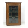 A George III oak corner cupboard, with single astragal glazed door, 75.2 by 41 by 107cm high.