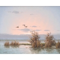 G. Van de Velde (20th century): three ducks in flight over a rush clad lake at dusk, signed lower le... 