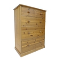 A modern pine chest of two over three drawers.
