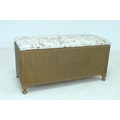 A vintage Lloyd Loom Lusty wicker blanket box, with floral upholstered seat and gold coloured body.