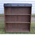An early to mid 20th century ebonised oak freestanding bookcase, with two shelves, 91 by 30 by 105cm... 