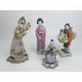 A group of four oriental figurines, a Hochst style Chinese lady carrying her wares, with cartwheel m... 