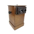 A Victorian table Stereoscope viewer of pillar box form, with mahogany case and carved decoration to... 