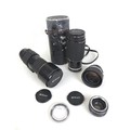 A group of Nikon lenses and lens caps, including a Nikkor 300mm f/4, a Zoom-Nikkor 80-200mm f/2.8 in... 