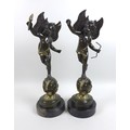 Two modern bronze sculptures of winged putti, cast in the Baroque style, one holding a flaming torch... 