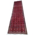 A Turkman runner, with red ground and multiple guls to field, narrow borders, 295 by 83cm.