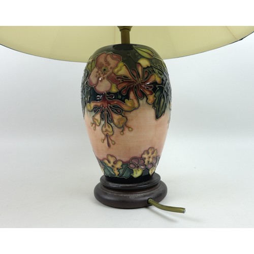 22 - A Moorcroft Pottery Oberon pattern table lamp, of ovoid form with circular wooden base and complimen... 