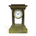 A Victorian brass mantel clock, of architectural form, the white enamel 1.75