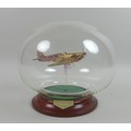 A modern glass sculpture of a Spitfire, by Northumbrian Glass, mounted in a clear glass sphere on wo... 