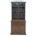 A George IV / William IV mahogany secretaire bookcase, decorated with floral patera and moulding, tw... 