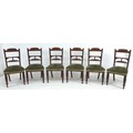 A set of six late Victorian mahogany dining chairs, with carved decoration, the seats upholstered in... 
