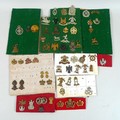 Over sixty WWI and later cap and shoulder badges, including Royal Hussars, Royal Fusiliers, Loyal Su... 