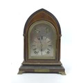 An Edwardian mahogany & inlaid mantel clock, of lancet form, the silvered dial with black Roman nume... 