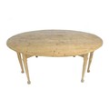 A large pine drop leaf dining table, 20th century, of oval form with turned tapering legs and pad fe... 