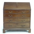 An early 19th century mahogany bureau, fall front with fitted interior over four graduating drawers,... 