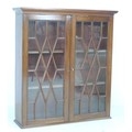A 19th century mahogany wall hanging display cupboard, twin astragal glazed doors enclosing two shel... 