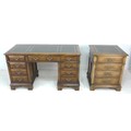 A modern stained oak twin pedestal desk, in the Georgian style, with inset green tooled leather skiv... 