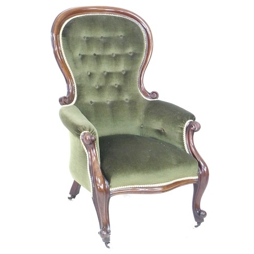 270 - A Victorian mahogany spoon back armchair, moulded frame and scroll arm ends, upholstered in green bu... 