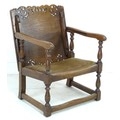 An early 20th century oak monk's chair, the pierced and carved tilt and slide top folding to form a ... 